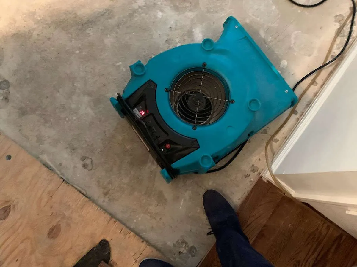 Air mover drying subfloor during Leak Detection & Repair in Rossford